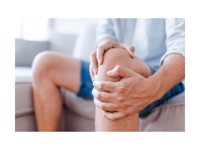 holding knee from IBD joint pain