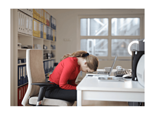 woman with IBD fatigue falling asleep at desk